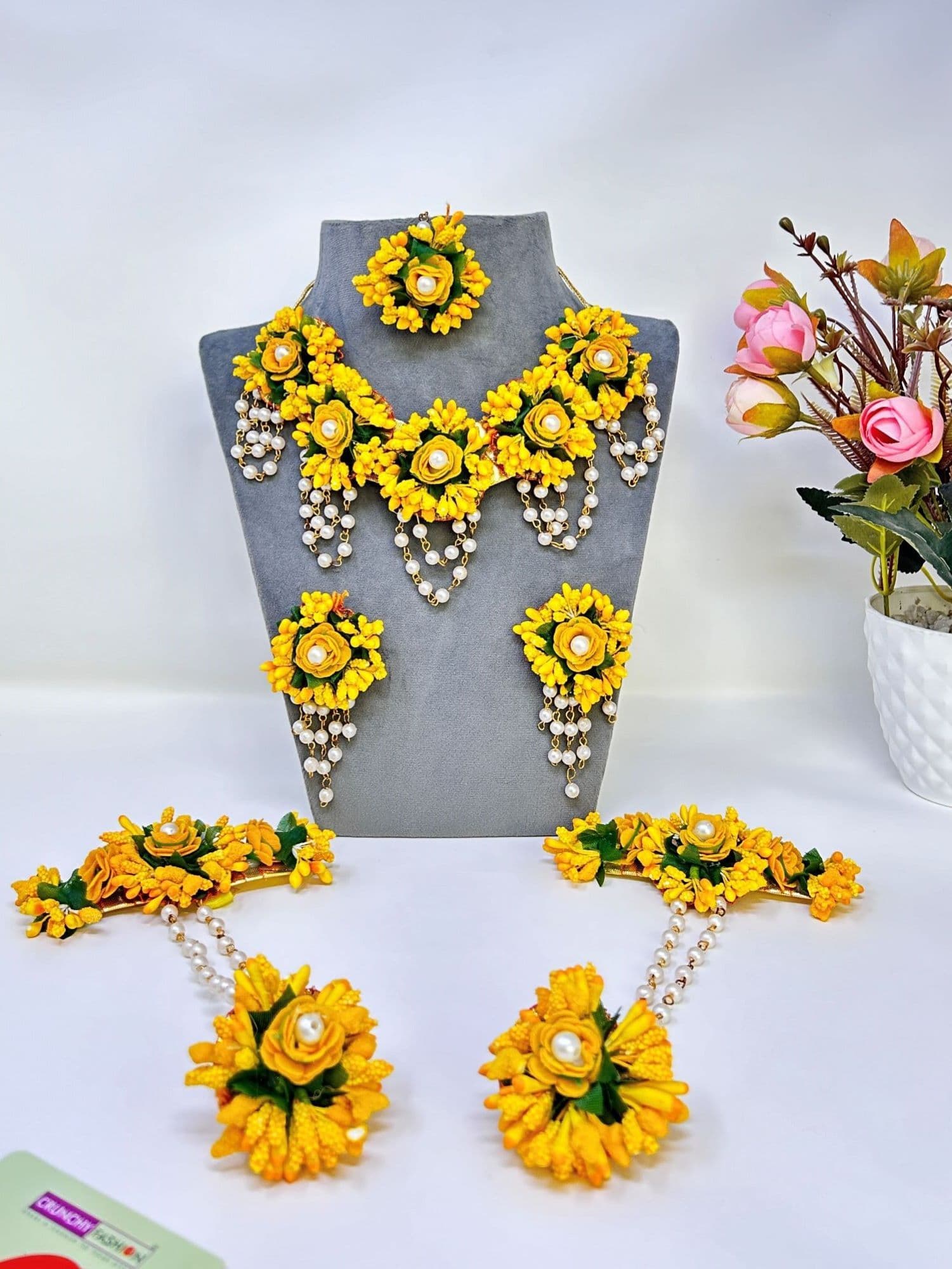 Handmade yellow flower jewellery set with beaded and pearl details, perfect for haldi or mehndi ceremonies, ideal for brides and girls.